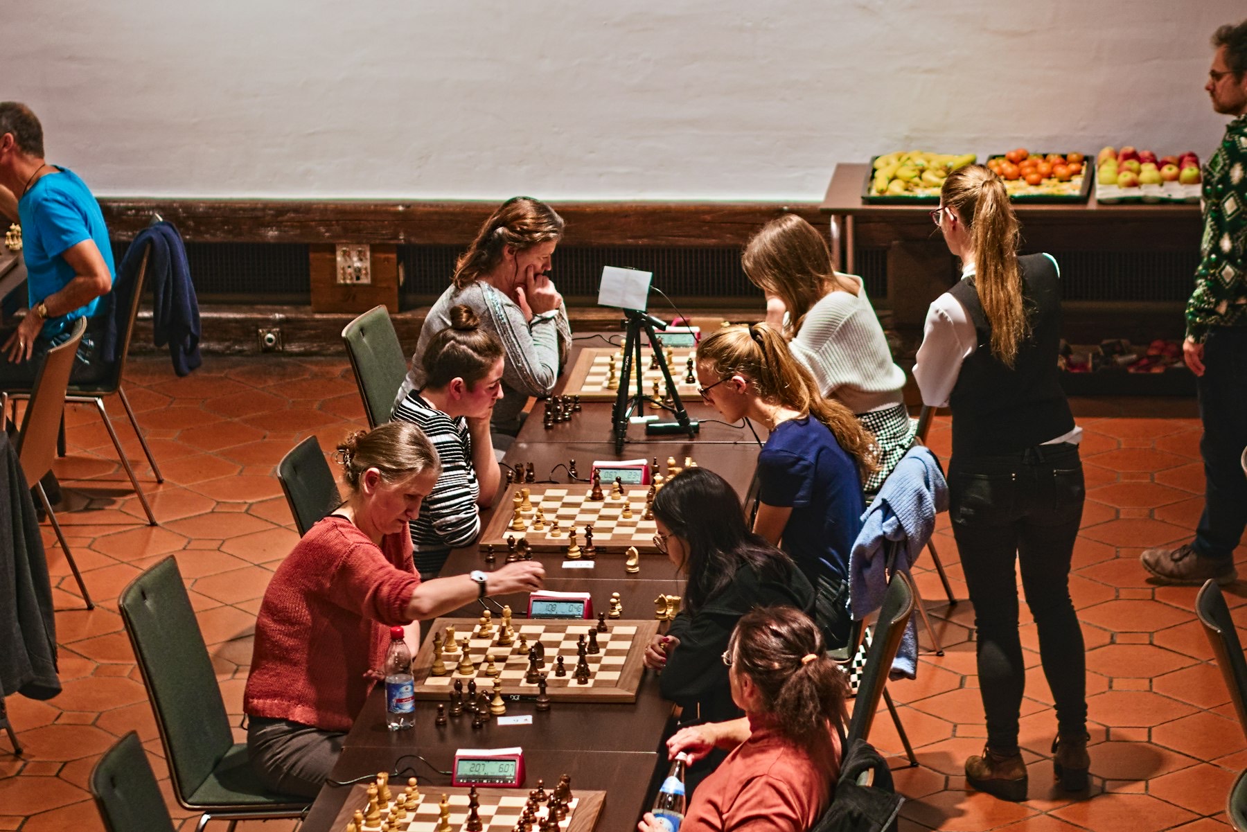 Players facing each other across chess boards in a club